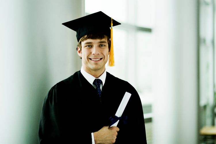 Photo of graduate with degree in hand