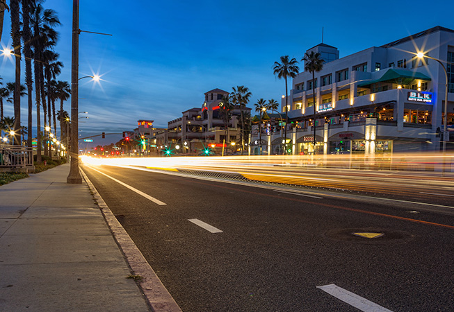 Car lights and shops at night