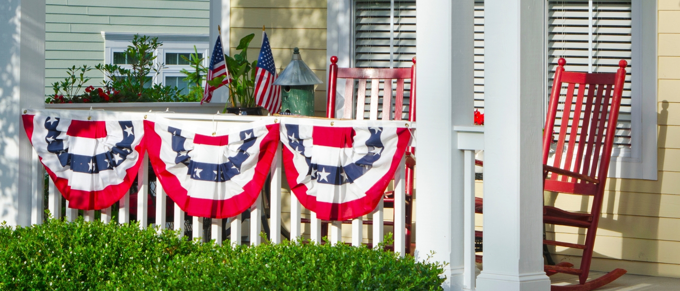 Porch with American flags and rocking chairs