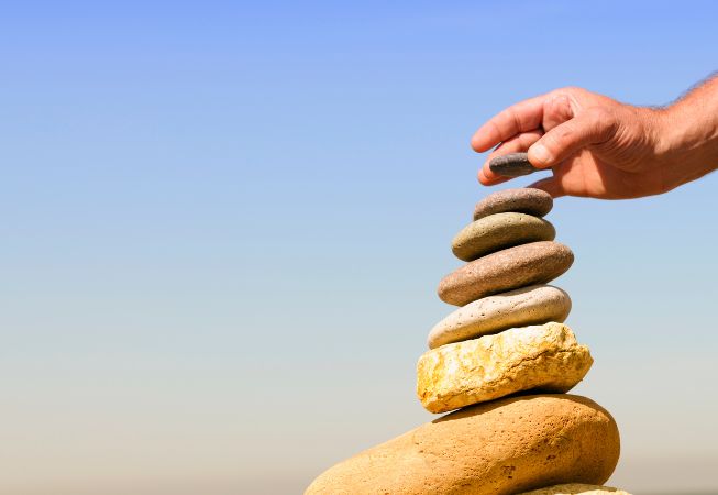 Person stacking stones